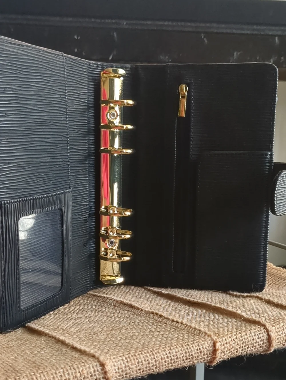 A6 Saffiano Binder In Black With Gold Hardware.